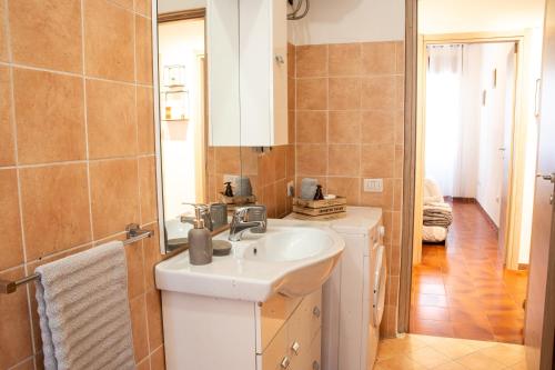 a bathroom with a sink and a mirror at Casa Smeralda Olbia in Olbia
