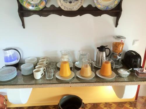 un bancone con piatti e brocche di succo d'arancia di Casa do Peso a Crato