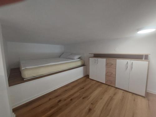 a small room with a bed and a cabinet at SPRING and SUMMER apartment near Ljubljana with FREE secure parking in Domžale