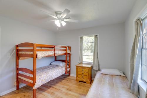 a bedroom with a bunk bed and a ceiling fan at The Old Parsonage Pindall House with Patio! 