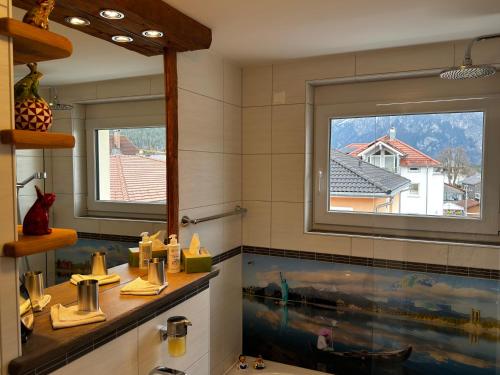 a bathroom with a large window and a sink at Ferienwohnung-Königsschlösser in Füssen