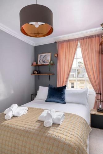 a bedroom with a bed with two towels on it at Beautiful apartment in Bath in Bath