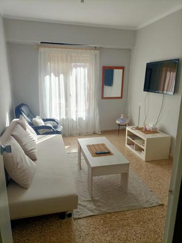 a living room with a white couch and a table at El Molino Buñol Apartamento in Buñol