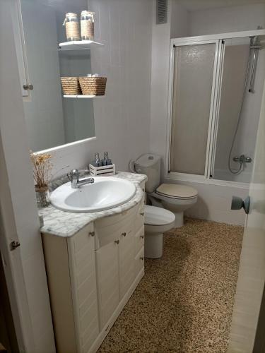 a bathroom with a sink and a toilet and a shower at El Molino Buñol Apartamento in Buñol