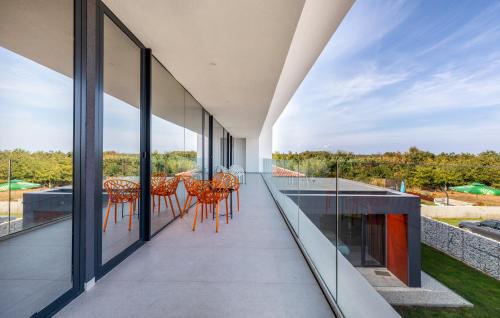 a view from the balcony of a house with chairs and tables at Villa Grande Arche Istria in Ližnjan
