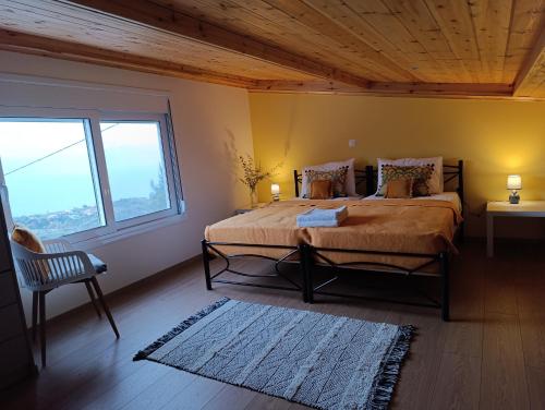 a bedroom with a large bed with a wooden ceiling at Altheas Maisonettes in Xylokastron