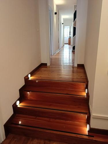a hallway with wooden stairs with lights on them at Affittacamere La Loggia in Venzone