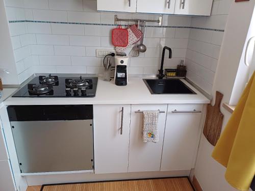 a small kitchen with a stove and a sink at B&b Adele in Capri