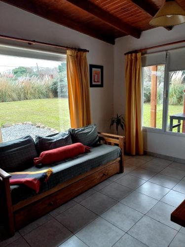a living room with a couch and a large window at Soñada in Tandil