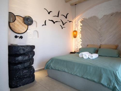 a bedroom with a bed with bats on the wall at Artemis by Kallisto Royal Suites in Ornos