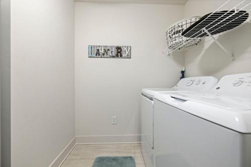 a laundry room with a washer and dryer at Calypso 3 New Relax Unwind Luxury PCB next to Pier Park 3 Bed 2 Bath Pool Hot Tub Tikki bar in Panama City Beach