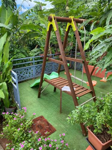 a playground with a swing in a garden at T3 VILLA DAGONI LOGONI in Koungou