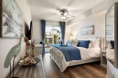a bedroom with a bed and a ceiling fan at Calypso 3 New Relax Unwind Luxury PCB next to Pier Park 3 Bed 2 Bath Pool Hot Tub Tikki bar in Panama City Beach