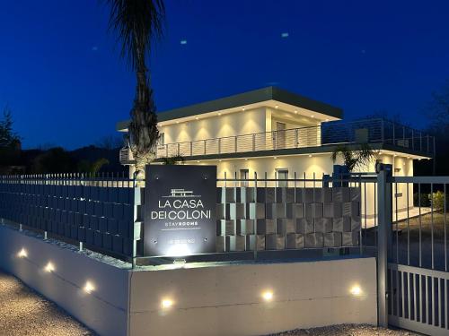 a large white building with a sign in front of it at La casa dei Coloni in Nola