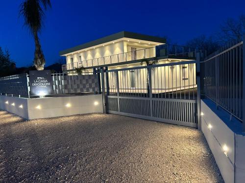 a house with a white gate with lights at La casa dei Coloni in Nola