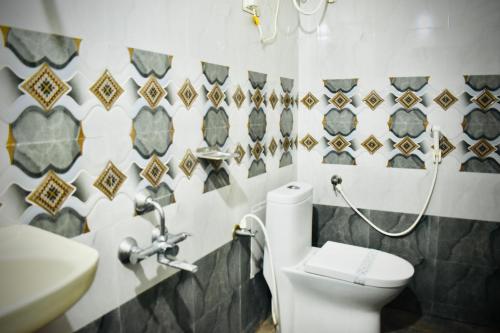 a bathroom with a toilet and a sink at Hotel Unique Stays in Rājampet