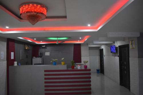 an office lobby with a red neon light and a counter at Hotel Unique Stays in Rājampet