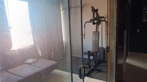 a bathroom with a shower with a bench and a window at Casa em rio verde in Rio Verde