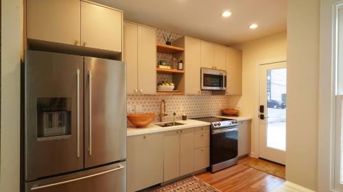 a kitchen with a stainless steel refrigerator and a sink at Beautiful Home Central Columbus in Columbus