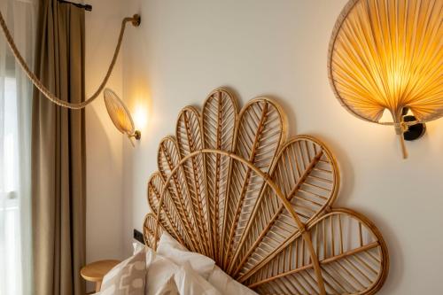 a large wooden decoration on a wall next to a lamp at Kotraba Alacati Hotel in Alacati