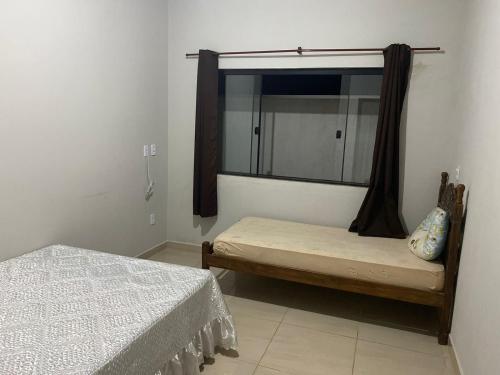 a bedroom with two beds and a mirror at Casa Bela Vista in São Roque de Minas
