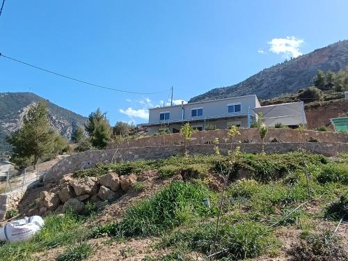 a house sitting on top of a hill at Altheas Maisonettes in Xylokastron