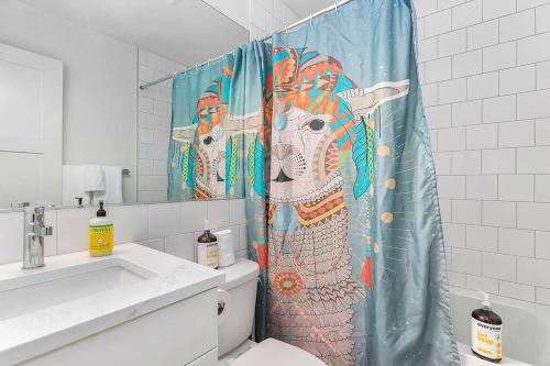 a bathroom with a shower curtain with an elephant on it at The Sweetest Hideaway - 81 Walkscore! in Seattle