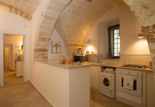 a kitchen with a sink and a stove top oven at Casa delle Volte - The Fab Stay in Brindisi