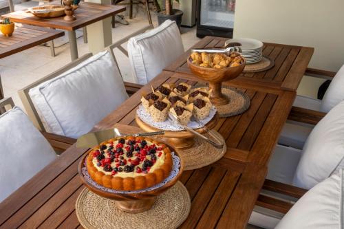 a table with a cake and other desserts on it at Kotraba Alacati Hotel in Alacati