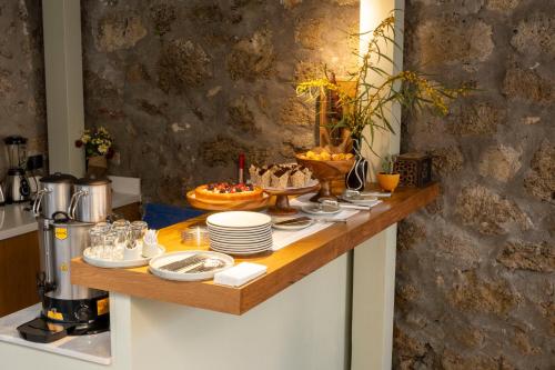 a table with plates and bowls of food on it at Kotraba Alacati Hotel in Alacati