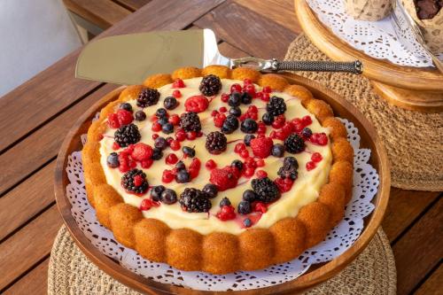 a pie with berries on top of it on a table at Kotraba Alacati Hotel in Alacati