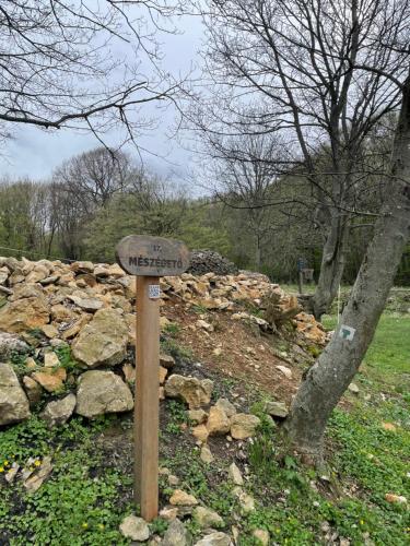 a sign in front of a pile of rocks at Bakonyi Porta Olaszfalu in Olaszfalu