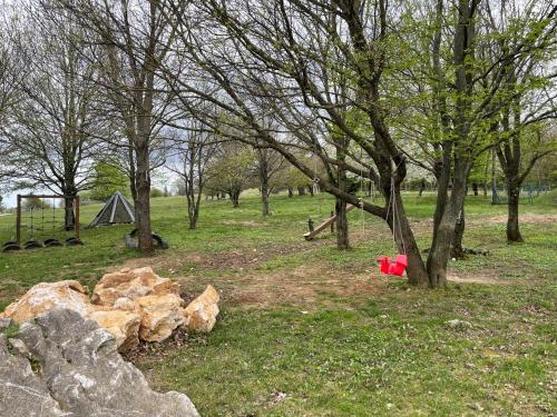 a group of rocks and trees and a tent at Bakonyi Porta Olaszfalu in Olaszfalu