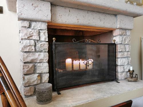 a fireplace with three candles in it at La casa nel borgo in Cavaso del Tomba
