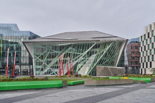 a large glass building in a city with buildings at Sonder at Britain Quay in Dublin