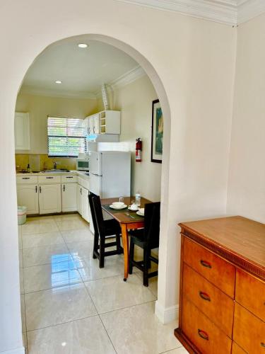 a kitchen with a table and chairs and a refrigerator at Colony Club Inn & Suites in Nassau