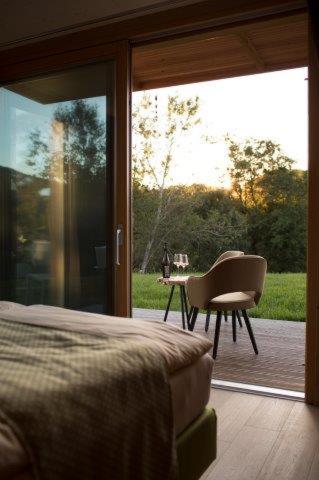 a bedroom with a bed and a desk and a window at Triad Wiener Alpen Bett DZ in Bad Schönau