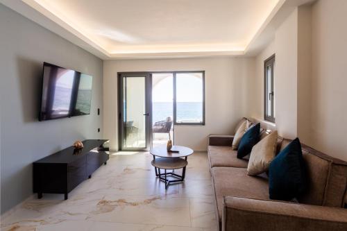 a living room with a couch and a table at Marina Apartments in Kardamili