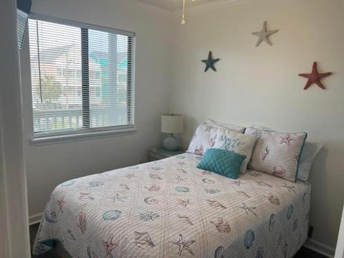 a bedroom with a bed with stars on the wall at Sea Shadow 205 Condo in Myrtle Beach