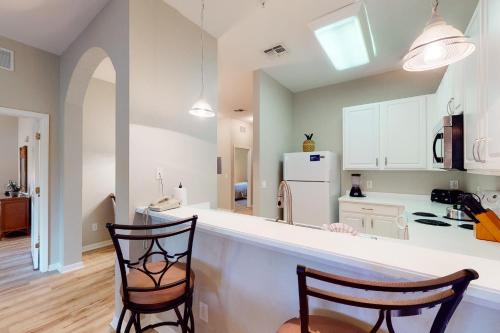 a kitchen with two chairs and a counter top at Bahama Bay Resort in Kissimmee