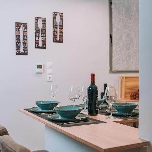 a table with bowls and wine glasses on it at Plaka Sofi Suite in Athens