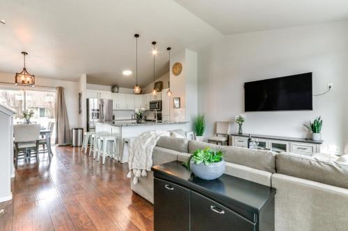 a living room with a couch and a kitchen at Spokane Valley Home with Fire Pit - 1 Mi to Trails! in Spokane Valley