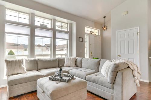 a living room with a large couch and a table at Spokane Valley Home with Fire Pit - 1 Mi to Trails! in Spokane Valley