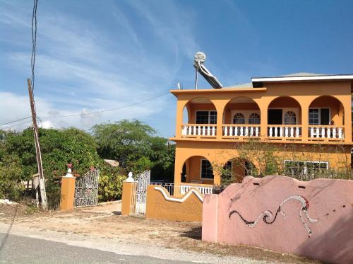 a house with a fence in front of it at Brytan Villa in Treasure Beach