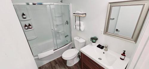 a bathroom with a toilet and a shower and a sink at The Lofts on Clematis 306 Downtown West Palm Beach in West Palm Beach