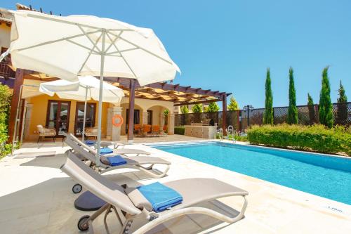 a villa with a swimming pool and a house at Luxury Villa AJ 06 with private heated pool in Paphos City