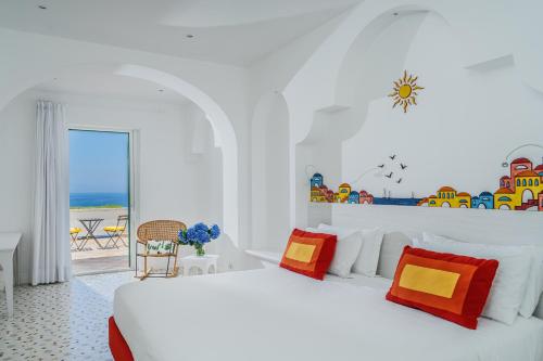 a bedroom with two beds and a view of the ocean at Hotel Le Terrazze in Conca dei Marini