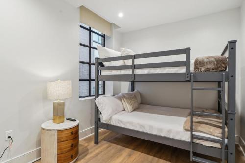 a bedroom with two bunk beds and a table at The Eleanor New Orleans in New Orleans