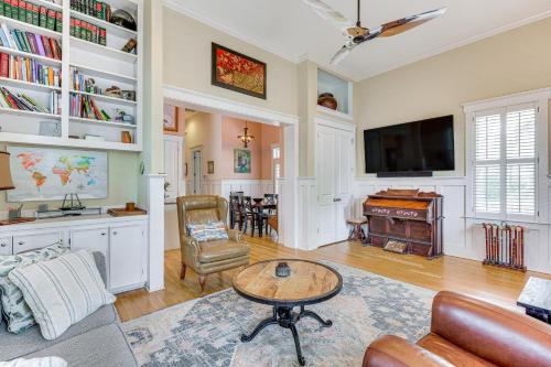 a living room with a couch and a table at Charming Wilmington Cottage - Walk to Downtown! in Wilmington