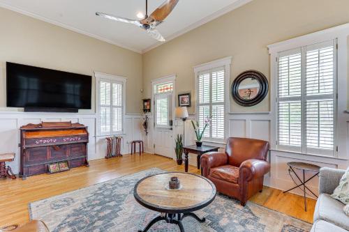 a living room with a tv and a couch and a table at Charming Wilmington Cottage - Walk to Downtown! in Wilmington
